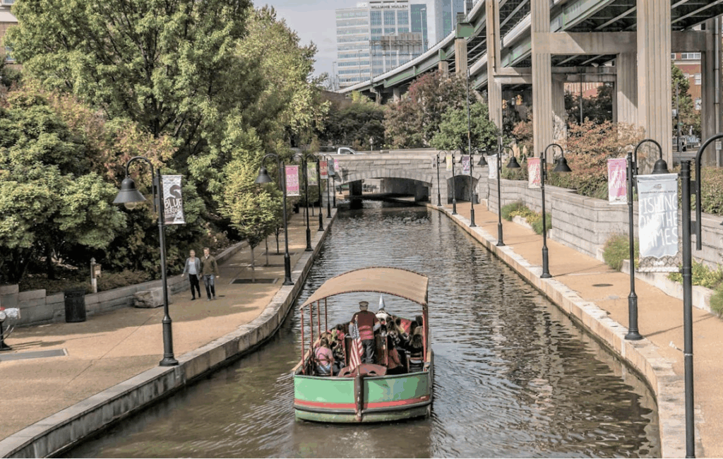 a canal boat makes its way along the canal in downtown Richmond